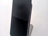 a cell phone that is sitting on top of a stand