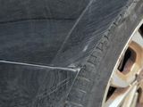 a close up of a car ' s tire on the side of the road