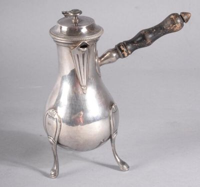 une cafetière en argent avec une poignée en bois, posée sur un socle