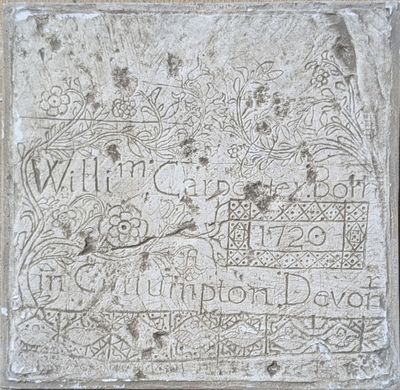 a close up of a stone plaque with writing on it