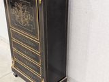 an antique black and gold painted cabinet against a white wall