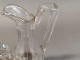 a glass pitcher sitting on top of a silver tray