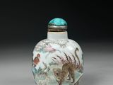an antique chinese snuff bottle decorated with animals and flowers
