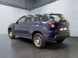 a picture of a blue pick up truck parked in a garage