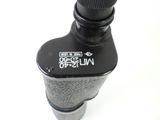 a close up of a black bottle with a black cap on it