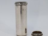 an image of a small silver cup next to a smaller silver cup