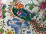a vase with a bird and flowers painted on it