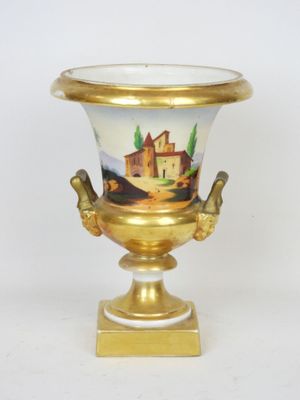 a gold and white vase with a painting on it