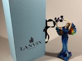 a figurine of a woman with a parrot in her hand