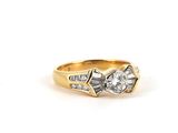 a close up of a diamond ring on a white background