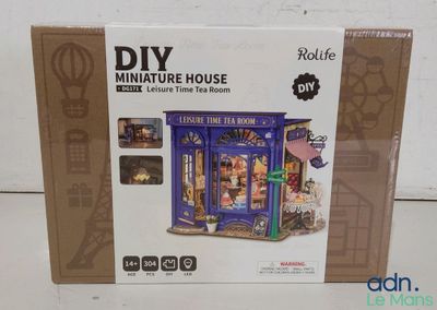 a box with a doll house inside of it