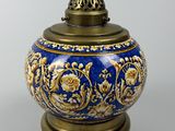 an image of a blue and gold vase sitting on top of a table