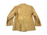 the back of a tan jacket with holes on it on a white surface