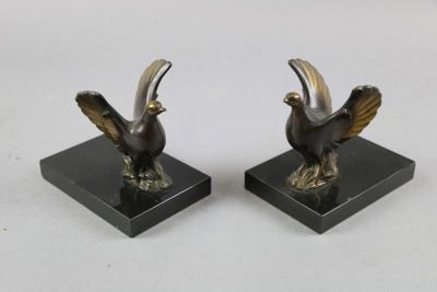 pair of bronze bird bookends on black marble bases
