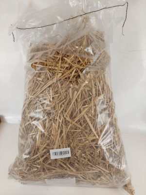 a bag of straw sitting on a table next to a cup of coffee