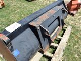 a large metal barrel sitting on a pallet in the grass
