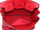 the inside of a red handbag with a zipper on it