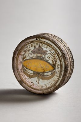 a close up of a small clock with a crown on it