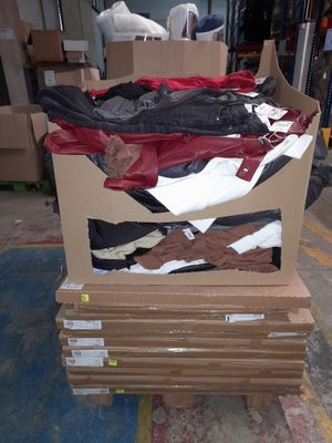 a cardboard box with a bunch of clothes in it