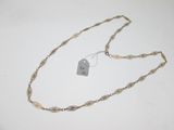 a close up of a necklace with a tag attached to it