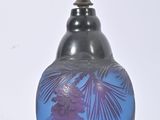 a blue vase with a purple flower on it