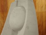 a sculpture of a white object on a wooden surface