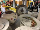 many plates and bowls on the counter in the store