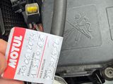 a person holding a car key in their hand with a tag attached to it