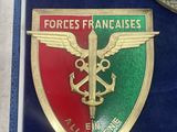 two badges on display in a blue case with a clock