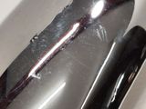 a close up of a black object on a white surface