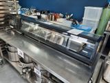 stainless steel counter top in a commercial kitchen with pots and pans on it