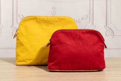 two red and yellow bags sitting on top of a wooden floor