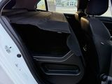 a white car with its door open and a black seat