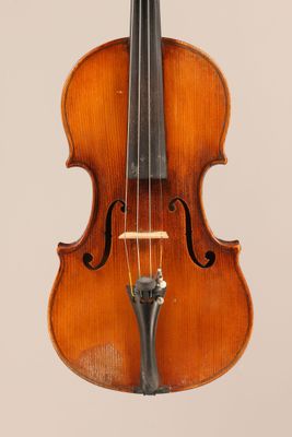 an old violin with a bow hanging from it ' s neck