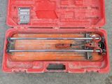 the tools are in the red case on the concrete floor