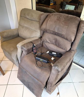 a recliner that is sitting on a tiled floor