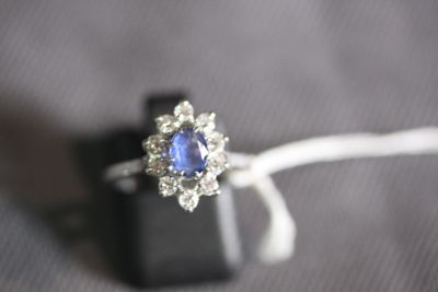 a ring with a blue sapphire and white diamonds on it