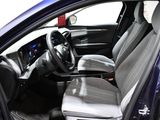 the interior of a blue car with a steering wheel and a dashboard
