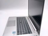a silver laptop with a blue sticker on it