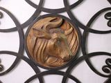 a metal wall sculpture of a bull on a white wall