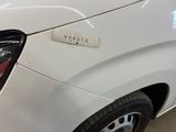 a close up of a white car with a sticker on it