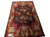 an image of a red rug with a floral design on it