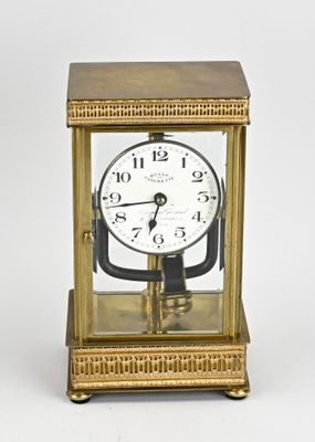 an image of a gold clock sitting on top of a table