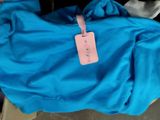 a blue bag with a pink tag on it