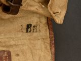 a brown bag with a brown handle on a black surface