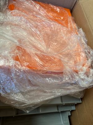 a cardboard box with a bunch of carrots in it