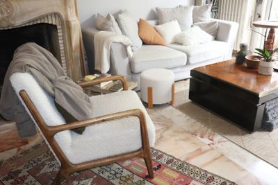 a living room with a couch, chair, coffee table and a fire place