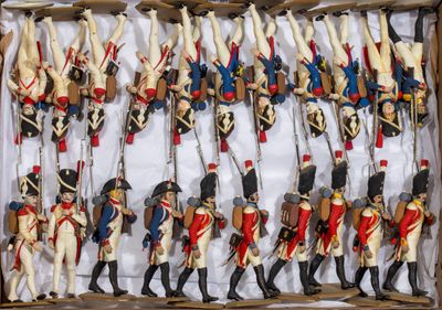 many figurines of soldiers that are in a box