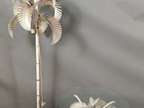 a table with a lamp and a palm tree on it