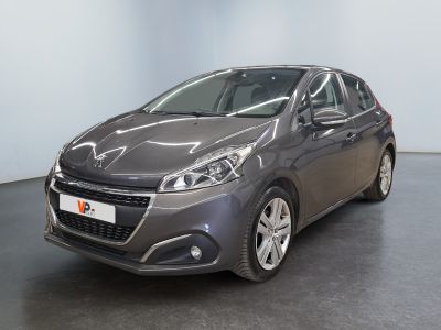 the grey car is parked in a large room with a black floor
